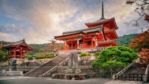 Kiyomizu-dera Temple in Kyoto surrounded by vibrant greenery and autumn colors