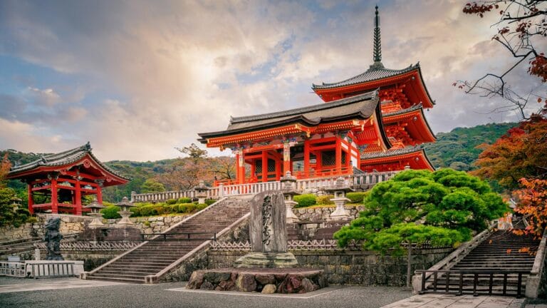 Kiyomizu-dera Temple in Kyoto surrounded by vibrant greenery and autumn colors