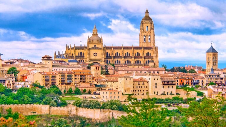 Panoramic view of Segovia, Spain, featuring the Cathedral of Segovia and surrounding historic buildings.