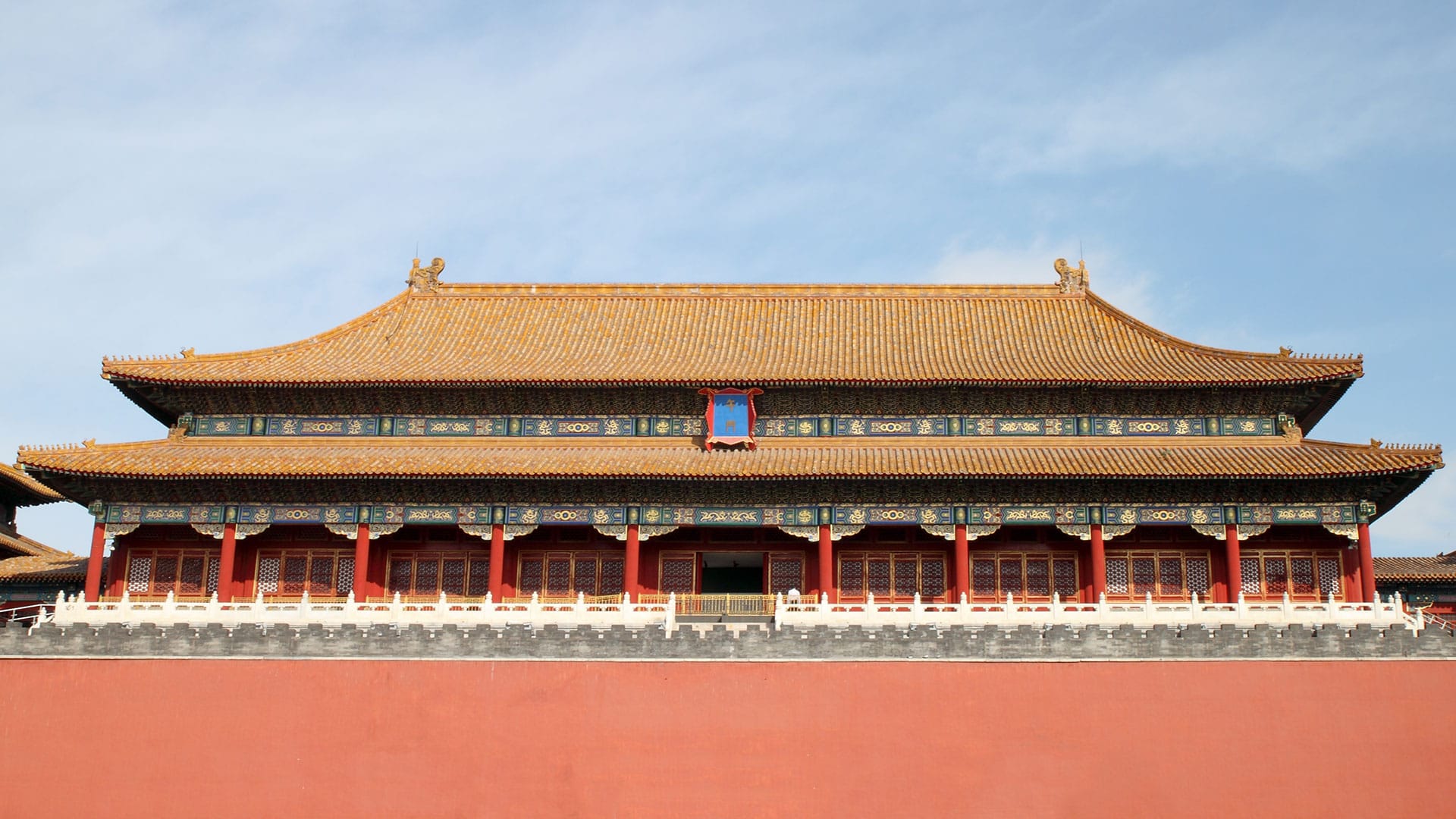 The majestic architecture of the Forbidden City in Beijing, showcasing intricate designs and vibrant colors against a clear blue sky.
